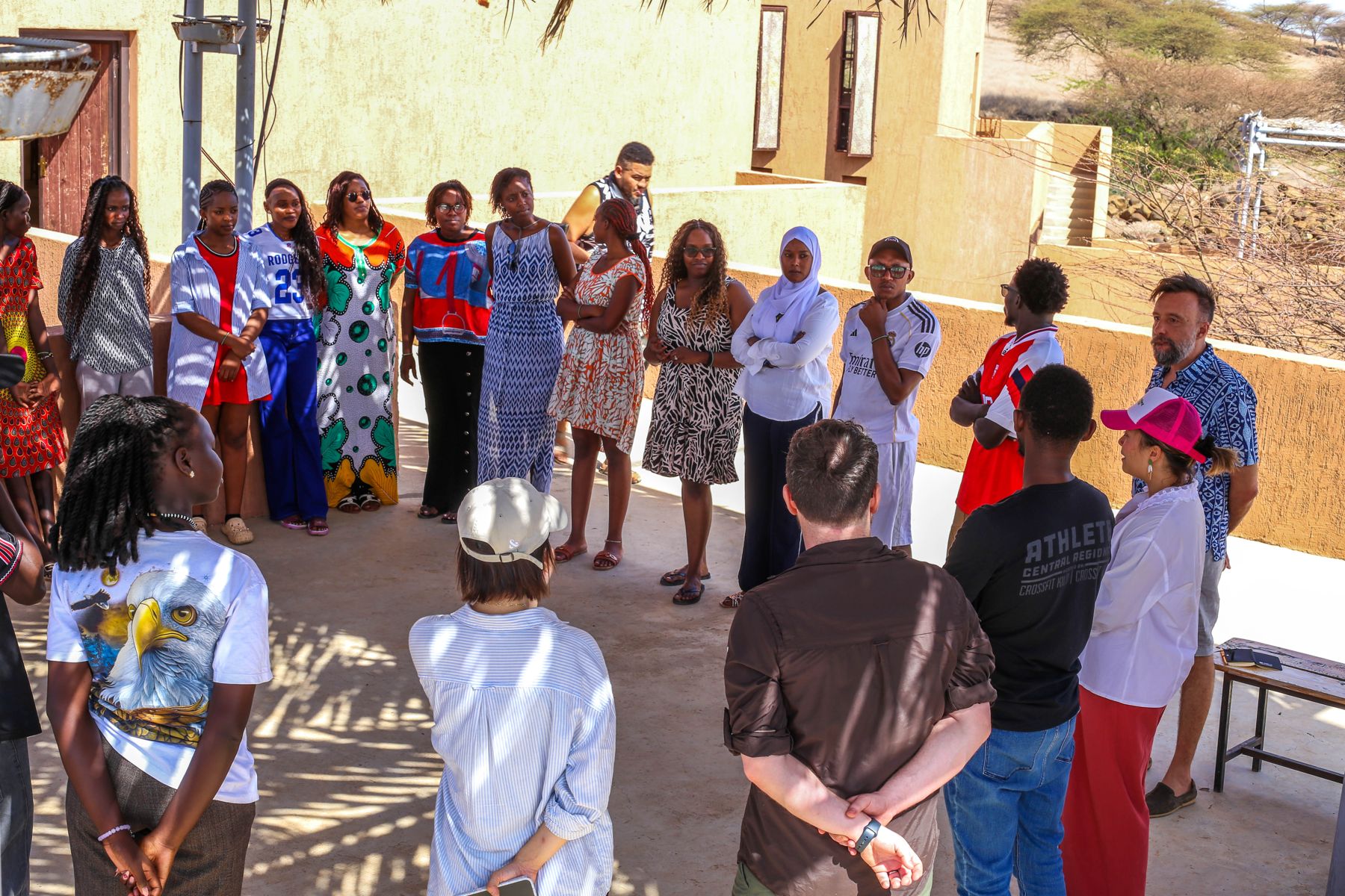 Apprentices and coaches in a morning stand-up at the Turkana hub